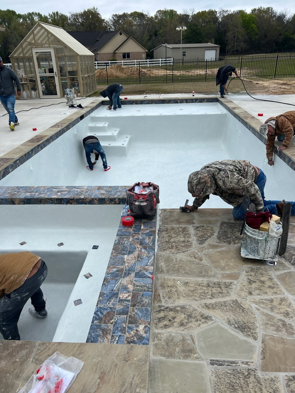 Workers building a pool